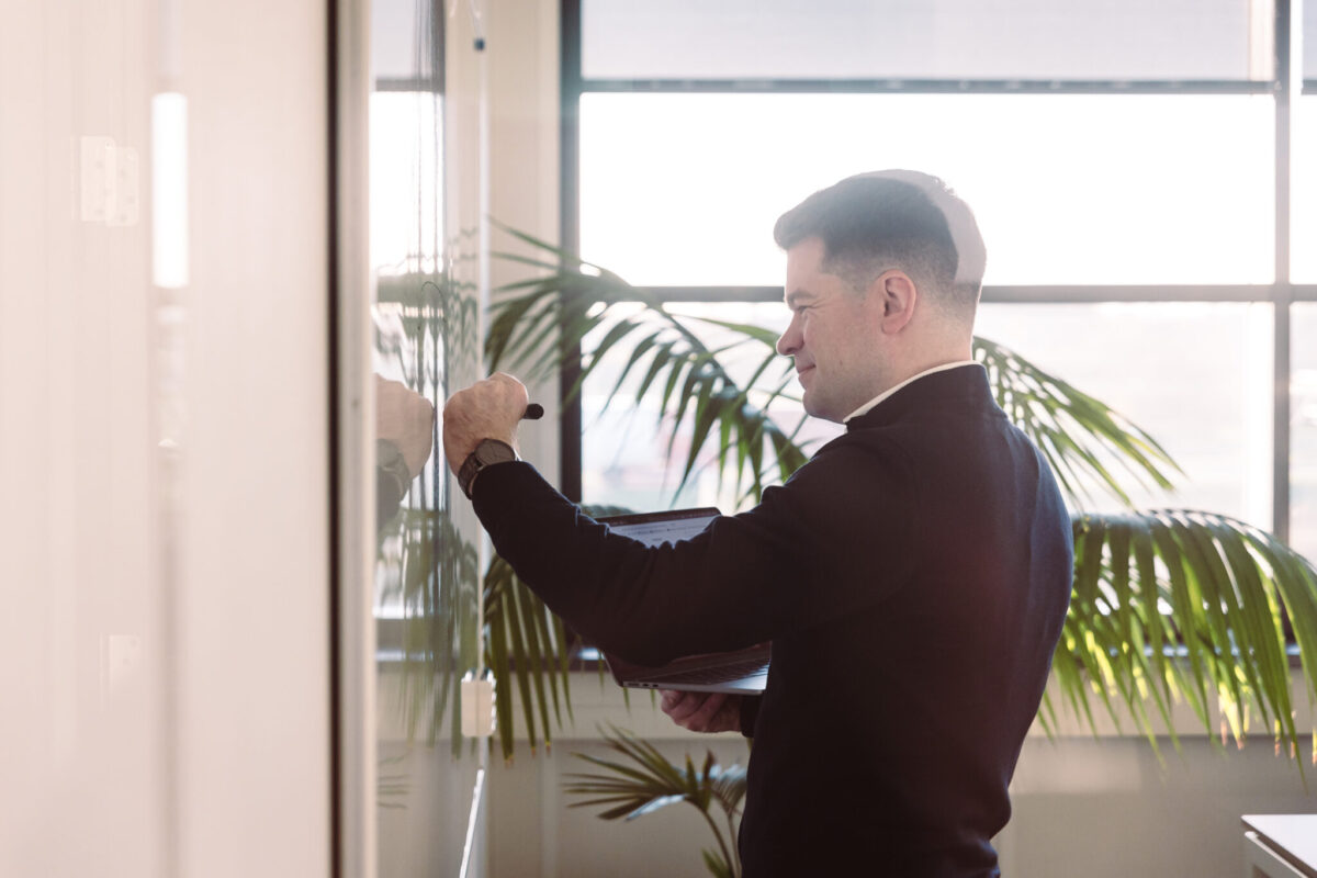 A person writing on a whiteboard.